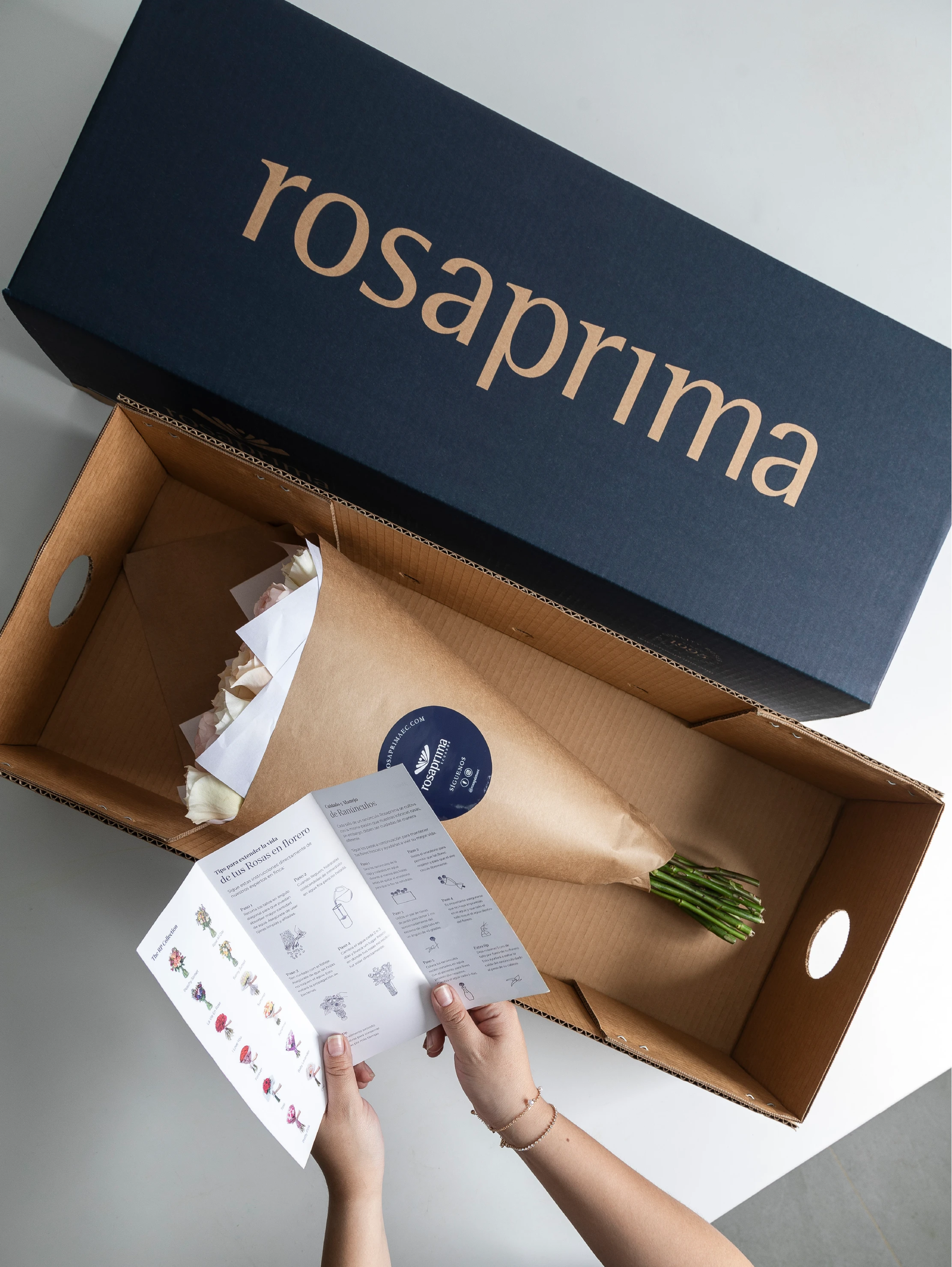 Bouquet of garden roses in a brown paper bag inside a Rosaprima box.