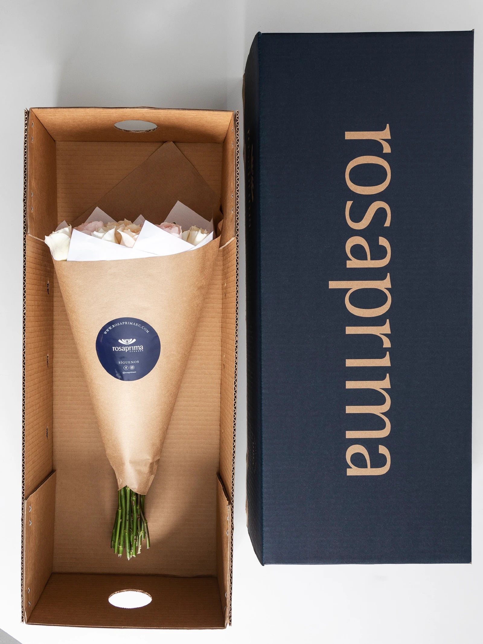 Bouquet of garden roses in a brown paper bag inside a Rosaprima box.