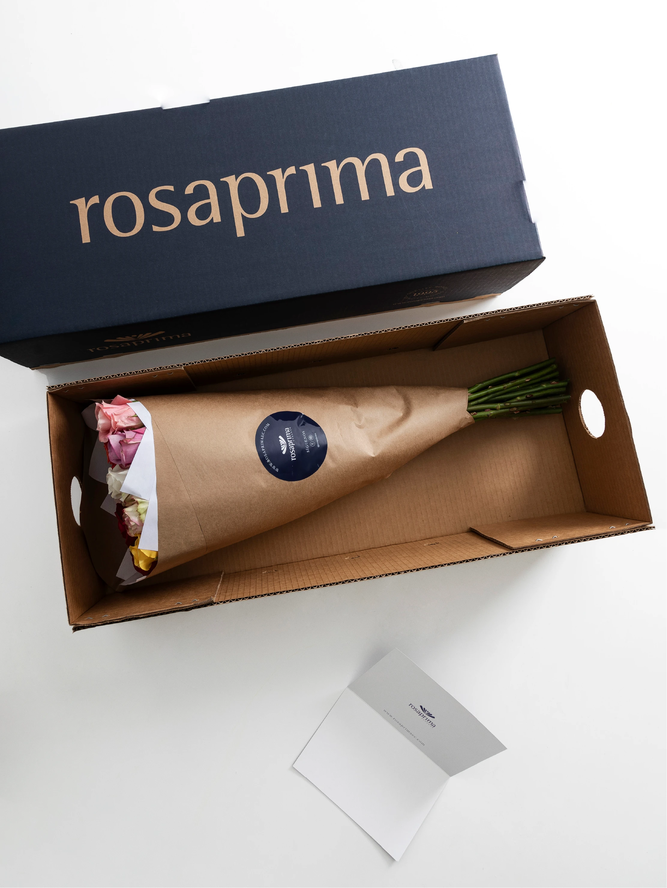 Bouquet of rosaprima roses in a Rosaprima box on a white background.